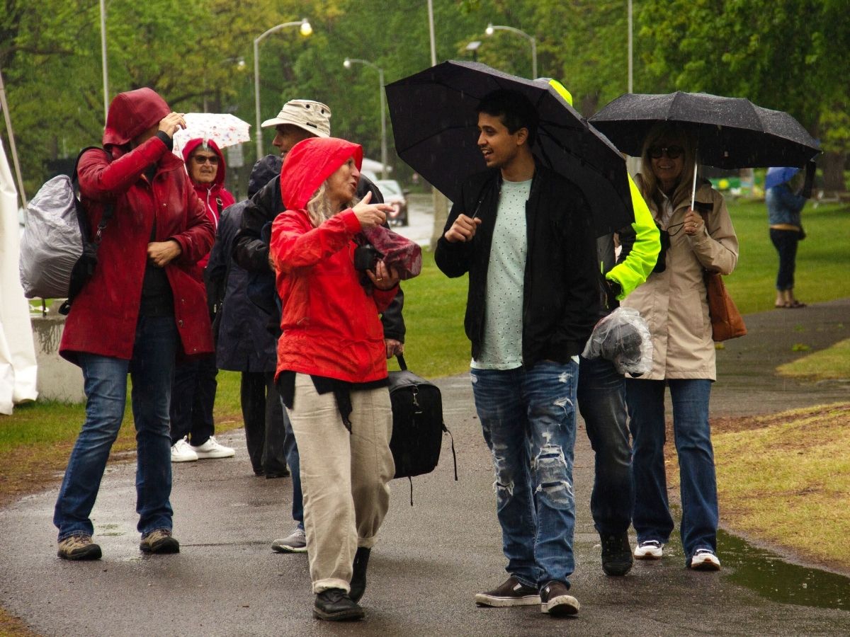 group of people walking in the rain