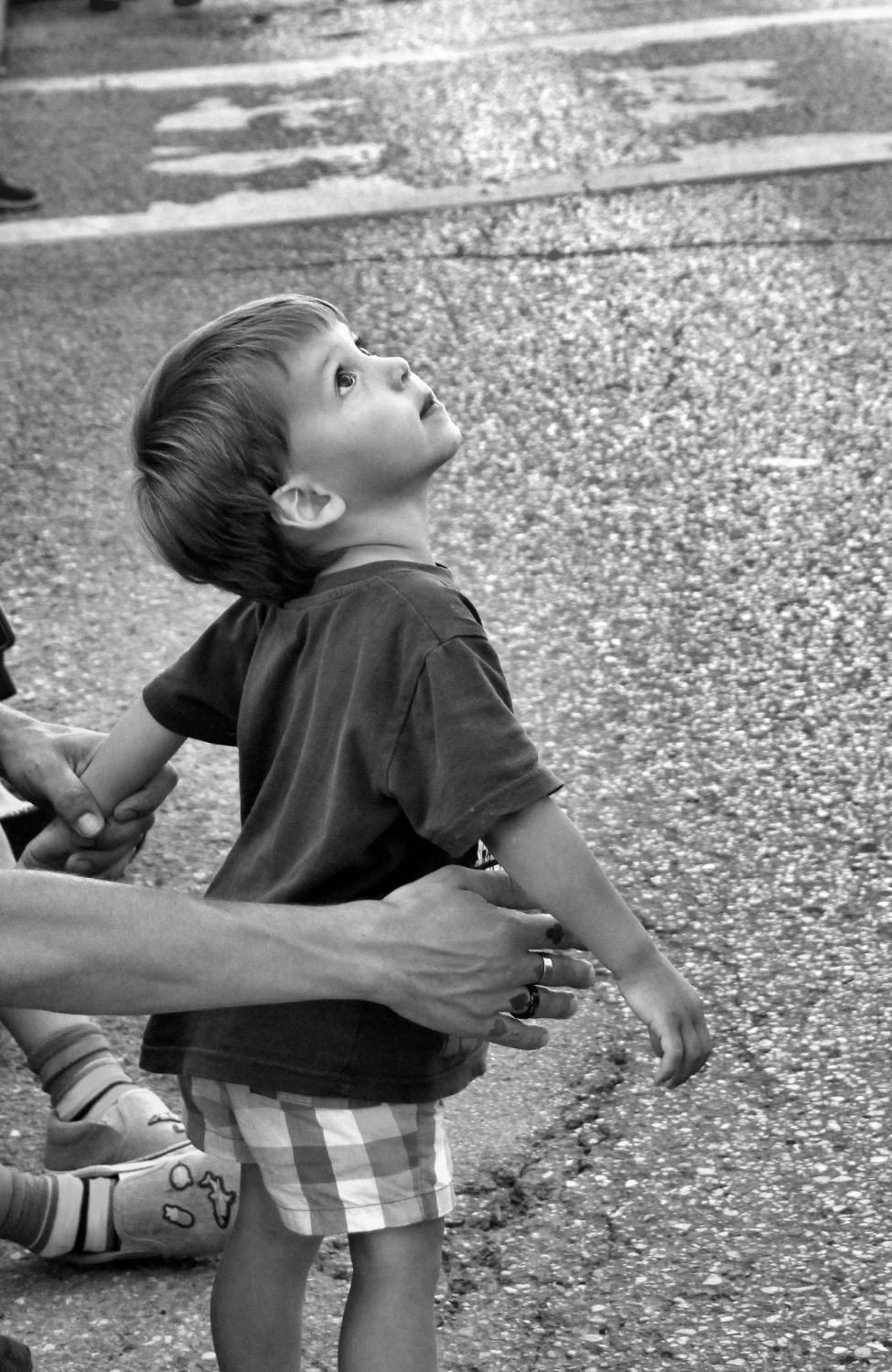 young boy looking up at the sky in wonder