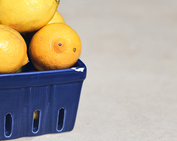 Lemons in chipped blue market basket